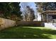 Fenced backyard with artificial turf, deck with pergola, and outdoor seating area at 1205 Club Walk Ne Dr, Brookhaven, GA 30319