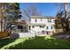 Backyard features manicured lawn, deck with pergola, and outdoor kitchen space at 1205 Club Walk Ne Dr, Brookhaven, GA 30319