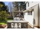 A backyard features a built-in outdoor kitchen and bar area with seating on a paver patio, leading to a deck with pergola at 1205 Club Walk Ne Dr, Brookhaven, GA 30319