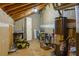 Unfinished basement with exposed wood beams, utility equipment, and paint supplies at 1205 Club Walk Ne Dr, Brookhaven, GA 30319
