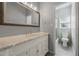 Bathroom featuring vanity with marble countertop, large mirror, and shower at 1205 Club Walk Ne Dr, Brookhaven, GA 30319