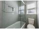 Bathroom featuring tiled shower and bath with glass door and window at 1205 Club Walk Ne Dr, Brookhaven, GA 30319