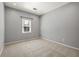 Neutral bedroom with plush carpet, large window, and ample natural light at 1205 Club Walk Ne Dr, Brookhaven, GA 30319