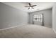 Large primary bedroom with ceiling fan, plush carpet, and large windows at 1205 Club Walk Ne Dr, Brookhaven, GA 30319