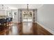 Bright dining area features wood floors, modern chandelier, and sliding doors to the outdoor deck at 1205 Club Walk Ne Dr, Brookhaven, GA 30319