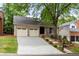 Lovely brick home with a two-car garage and a nicely landscaped front yard at 1205 Club Walk Ne Dr, Brookhaven, GA 30319