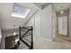 Hallway with skylight allowing natural light to accent black railing and doors at 1205 Club Walk Ne Dr, Brookhaven, GA 30319