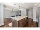 Kitchen island with built-in microwave, storage drawers, and a view of the open-concept living space at 1205 Club Walk Ne Dr, Brookhaven, GA 30319