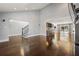 Open-concept living area with hardwood floors, staircase, wet bar, and dining area beyond at 1205 Club Walk Ne Dr, Brookhaven, GA 30319