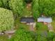 Aerial view of the property showcasing the house, mature trees, and surrounding landscape at 1217 Topaz Ln, Villa Rica, GA 30180
