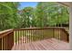 The deck overlooks the large fenced back yard that has a fire pit and a play set at 1217 Topaz Ln, Villa Rica, GA 30180
