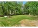 The large fenced back yard features a play set, a fire pit, and space for outdoor living at 1217 Topaz Ln, Villa Rica, GA 30180