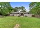 Spacious backyard with lush lawn, mature trees, and access from the house at 1217 Topaz Ln, Villa Rica, GA 30180