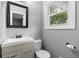 Bathroom featuring modern vanity, mirror, updated fixtures and a window at 1217 Topaz Ln, Villa Rica, GA 30180