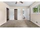 Bedroom with neutral carpet, closet and bathroom access and a ceiling fan at 1217 Topaz Ln, Villa Rica, GA 30180