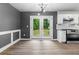Open dining area leading to kitchen with backyard deck access through glass doors at 1217 Topaz Ln, Villa Rica, GA 30180