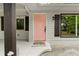 Close-up of the cheerful pink front door framed by dark shutters and a well-maintained porch at 1217 Topaz Ln, Villa Rica, GA 30180