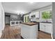 Modern kitchen boasts an island, white cabinets, stainless steel appliances, and subway tile backsplash at 1217 Topaz Ln, Villa Rica, GA 30180