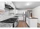 Well-appointed kitchen features granite counters, stainless appliances, subway tile, and center island with wood top at 1217 Topaz Ln, Villa Rica, GA 30180