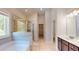Modern bathroom featuring a soaking tub, glass-enclosed shower, and dual vanity sinks at 1673 Dover Creek Ln, Lawrenceville, GA 30045