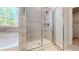Close-up of the elegant walk-in shower with upgraded tile in a modern bathroom at 1673 Dover Creek Ln, Lawrenceville, GA 30045