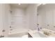 Well-lit bathroom featuring a tub-shower combination and modern fixtures at 1673 Dover Creek Ln, Lawrenceville, GA 30045