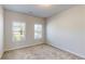 Neutral bedroom with carpet and two windows providing natural light at 1673 Dover Creek Ln, Lawrenceville, GA 30045