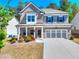 Charming two-story home with brick and siding, attached garage, and a well-maintained front yard at 1673 Dover Creek Ln, Lawrenceville, GA 30045