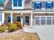 Beautiful front entrance of a brick home featuring a two-car garage and landscaped yard at 1673 Dover Creek Ln, Lawrenceville, GA 30045