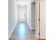 Bright hallway with gleaming hardwood floors leading to a glass-paned door at 1673 Dover Creek Ln, Lawrenceville, GA 30045