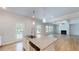 Open-concept kitchen with a granite island, fireplace, and access to the backyard at 1673 Dover Creek Ln, Lawrenceville, GA 30045
