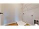 Laundry room with wood floor, washer hookups, and metal shelf at 1673 Dover Creek Ln, Lawrenceville, GA 30045