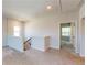 Cozy upstairs living room provides access to a staircase and multiple bedroom doorways at 1673 Dover Creek Ln, Lawrenceville, GA 30045