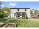 Backyard view of home featuring a covered patio, garden beds, and lush greenery at 1952 Don Juan Ln, Decatur, GA 30032