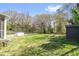 Large, grassy backyard featuring mature trees, garden beds, and a storage shed offers a private outdoor space at 1952 Don Juan Ln, Decatur, GA 30032