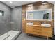 Bathroom features a glass shower, double sinks, and a wood paneled wall with a large mirror at 1952 Don Juan Ln, Decatur, GA 30032
