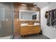 Bathroom features a glass shower, double sinks, and a wood paneled wall with a large mirror at 1952 Don Juan Ln, Decatur, GA 30032