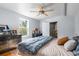 Bedroom features hardwood floors, ceiling fan, bedside tables, a comfortable bed, and a doorway to the bathroom at 1952 Don Juan Ln, Decatur, GA 30032