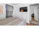 A secondary bedroom with a television mounted on the wall, and view into an adjacent room at 1952 Don Juan Ln, Decatur, GA 30032