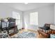 Bright bedroom with hard wood flooring, large windows and an inviting leather chair at 1952 Don Juan Ln, Decatur, GA 30032