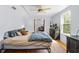 Bright bedroom features a ceiling fan, area rug, light-colored walls, and a view through the doorway to the next room at 1952 Don Juan Ln, Decatur, GA 30032