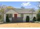 Charming single-story brick home with a red front door, mature landscaping, and a well-maintained lawn at 1952 Don Juan Ln, Decatur, GA 30032