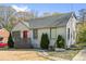 Charming painted brick home with a gray shingled roof, red front door, and manicured landscaping at 1952 Don Juan Ln, Decatur, GA 30032