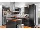 Modern kitchen features dark cabinets, butcher block countertops, stainless steel appliances, and herringbone backsplash at 1952 Don Juan Ln, Decatur, GA 30032