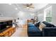 Open living room features a lofted ceiling, light-colored walls, hardwood floors, and large sofa at 1952 Don Juan Ln, Decatur, GA 30032