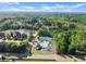Overhead view showcasing a pool, tennis courts, a lake, and residential areas in a neighborhood at 440 Hunt River Way, Suwanee, GA 30024