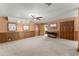 Finished basement features a neutral color scheme, wood trim, a ceiling fan and carpeted floors at 440 Hunt River Way, Suwanee, GA 30024