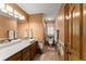 Bathroom features double vanity, tiled walls, and walk-in shower and linen closet at 440 Hunt River Way, Suwanee, GA 30024