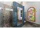 Spa-like bathroom showcases tiled shower, arched window, and contemporary fixtures at 440 Hunt River Way, Suwanee, GA 30024