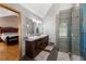 Stylish bathroom features double vanity, modern fixtures, and tiled shower with glass accents at 440 Hunt River Way, Suwanee, GA 30024